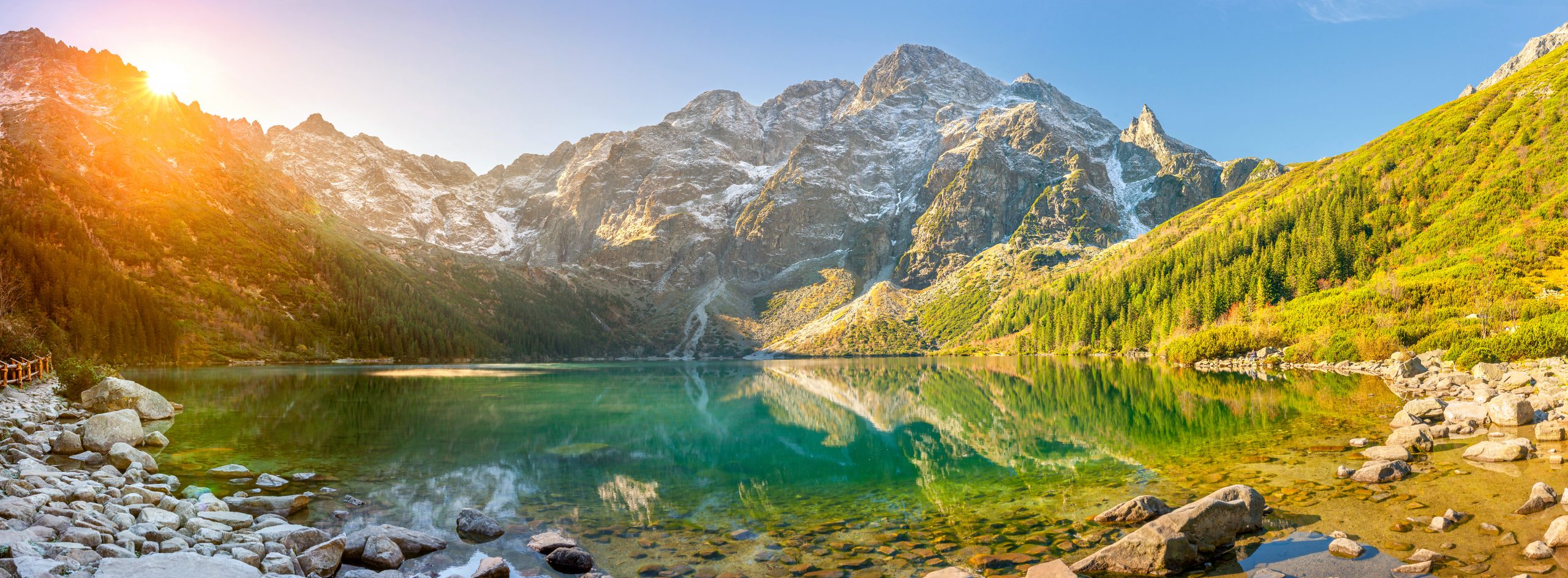 Tatra National Park, a lake in the mountains at the dawn of the sun. Poland